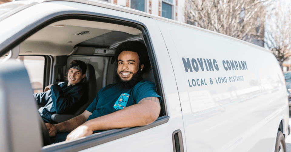 Man with a big smile driving a moving van 