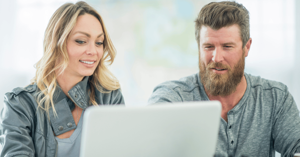 Woman and man sitting together looking at a computer screen